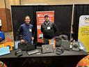 NutKase trade show booth displaying rugged laptop and tablet protective cases with team members presenting education technology solutions.
