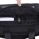 Top-down view of a black zippered bag opened to show the interior compartments, with a hand pulling the zipper back; inside are a smartphone, two pens, and papers organized in separate pockets.